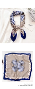 Detail showing retro houndstooth scarf with chain patterns and silk texture