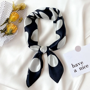 Elegant silk scarf with black and white polka dots in a vintage French knot style