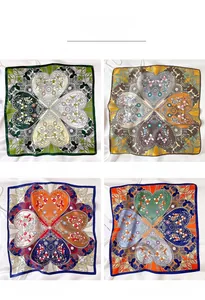 Detail display of silk square scarves in green, yellow, navy and orange floral patterns