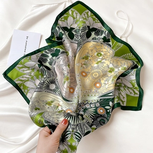 Detail of premium silk square scarf featuring vintage floral and geometric prints