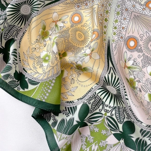 Detail of silk scarf with floral and mandala print in green and pink hues