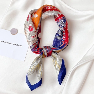 Elegant floral print silk square scarf with geometric patterns on a white satin background