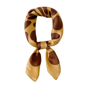 Elegant silk scarf featuring a brown giraffe spot pattern on a clean white background