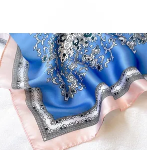 Detailed close-up of paisley silk scarf with smooth texture and fine stitched edges
