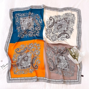 Detail of paisley silk scarf with four-color blocking and vintage floral patterns