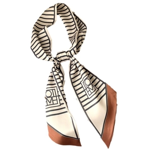 Slim geometric striped scarf with black and white patterns and caramel brown trim