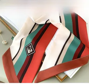 Detail of colorful striped silk scarf showing fine inner stitching and pointed ends