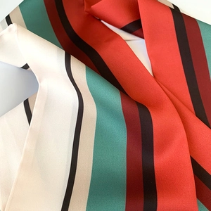 Detailed view of striped silk twill skinny scarf showing fine texture and vibrant colors