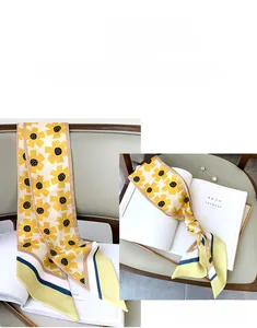 Detail of sunflower pattern silk scarf used as a decorative headband on a book