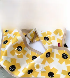 Close-up of silky sunflower pattern neck scarf with premium floral fabric texture