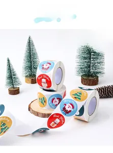 Detail of Christmas snowman and Santa stickers on a roll for festive gift packaging