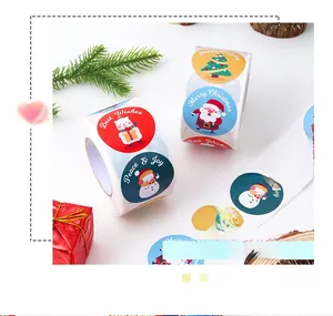 Close-up of colorful cartoon snowman and Santa Christmas seal labels on a roll for gifts