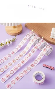Roll of round Valentine's Day stickers with red hearts and Made with Love text