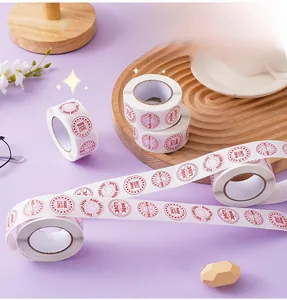 Detail of round 'MADE with LOVE' stickers on a roll for Valentine gifts and packaging