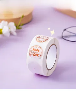 Detail of round 'MADE with LOVE' adhesive stickers on a roll for gift wrapping