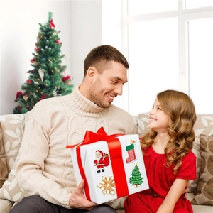 Waterproof holographic Christmas stickers on gift box during father and daughter holiday celebration