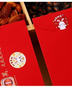 Close-up of red Chinese New Year red envelopes with cute rabbit stickers and gold foil
