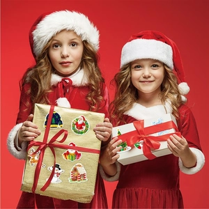 Children holding holiday gift boxes decorated with festive Christmas character stickers