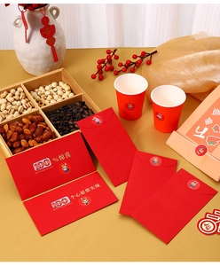 Detail view of Chinese New Year red envelopes with golden rabbit stickers and paper cups
