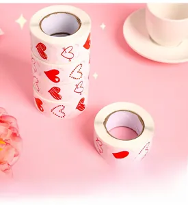 Detail of four heart pattern adhesive sticker rolls with diverse red love motifs