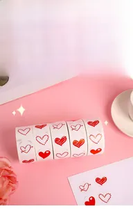 Close-up of heart-shaped stickers on a roll for Valentine's gift wrapping and DIY decor