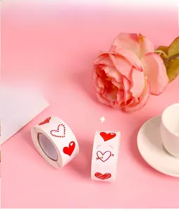 Detailed view of 500 heart-shaped red adhesive stickers on roll for gift decoration