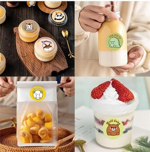 Detail of round cartoon animal reward stickers used as decorative seals on dessert packaging