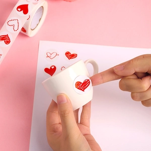 Roll of heart stickers for Valentine's Day gift decoration on a pink background