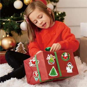 Holographic Christmas stickers featuring Santa and Snowman on a red gift box setup
