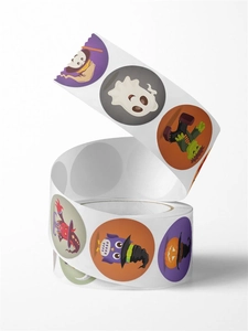 Macro shot of Halloween stickers roll featuring cartoon ghost and pumpkin illustrations