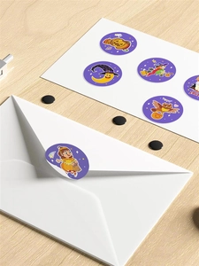 Halloween stickers on white envelope closure featuring pumpkin and witch designs
