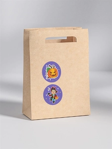 Detail of Halloween pumpkin and pirate stickers on brown kraft paper gift bag