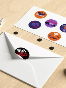 Detailed view of Halloween stickers as envelope seals on light wood background