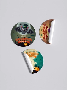 Close-up of Halloween stickers with pumpkin and ghost motifs showing adhesive quality