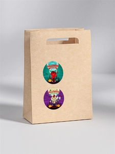 Detail of Halloween round stickers with devil and monster motifs on a brown paper bag