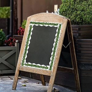 Eucalyptus leaf bulletin board border sticker with wavy edge on a wooden chalkboard