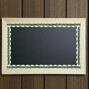 Green eucalyptus leaf border sticker decorating a blackboard for classroom bulletin boards