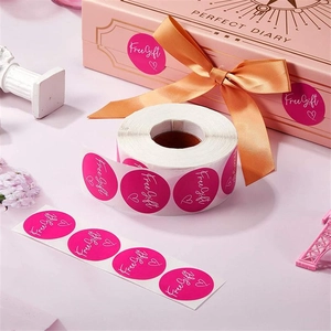 Macro detail of magenta Free Gift stickers on gift box with elegant ribbon and decorations