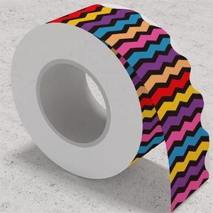 Macro detail of colorful scalloped border trim stickers in a roll with vibrant wave patterns