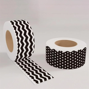 Close-up of decorative wave and white polka dot bulletin board border stickers on rolls