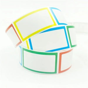 Close-up of blank label stickers with colorful borders on a roll for organization