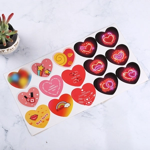 Golden foil heart-shaped Valentine's Day stickers on a white marble background