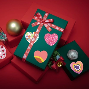Heart-shaped adhesive stickers with assorted patterns on gift boxes for festive decoration