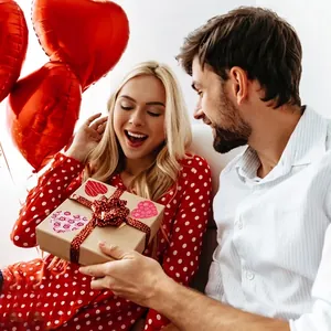 Romantic Valentine heart stickers on a craft gift box with red polka dot ribbon decoration