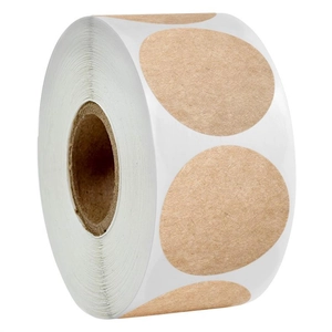 Close-up of circular kraft paper adhesive labels on a roll for packaging and DIY