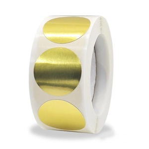 Macro detail of glossy golden round dot sticker roll with metallic brushed texture finish