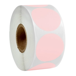 Pink round color-coded dot label stickers on a white roll with cardboard core