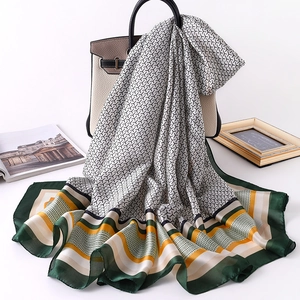Silk-feel rectangular scarf with black and white geometric patterns and striped borders