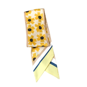 Narrow skinny scarf with sunflower print and geometric stripes in bright yellow
