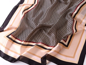 Macro detail of geometric pattern and silky texture on large printed scarf shawl